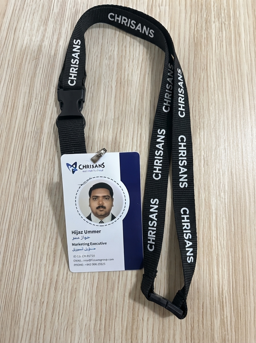 Chrisans Solutions PVC employee ID card in Kuwait — printed both sides with semi-gloss finish and clipped to a black woven lanyard
